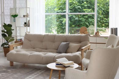 Photo of Stylish sofa and other furniture in living room. Interior design