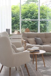 Photo of Stylish sofa and other furniture in living room. Interior design