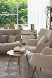 Photo of Stylish sofa and other furniture in living room. Interior design