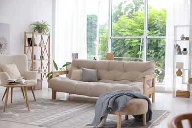 Photo of Stylish sofa and other furniture in living room. Interior design