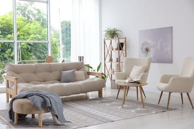 Photo of Stylish sofa and other furniture in living room. Interior design