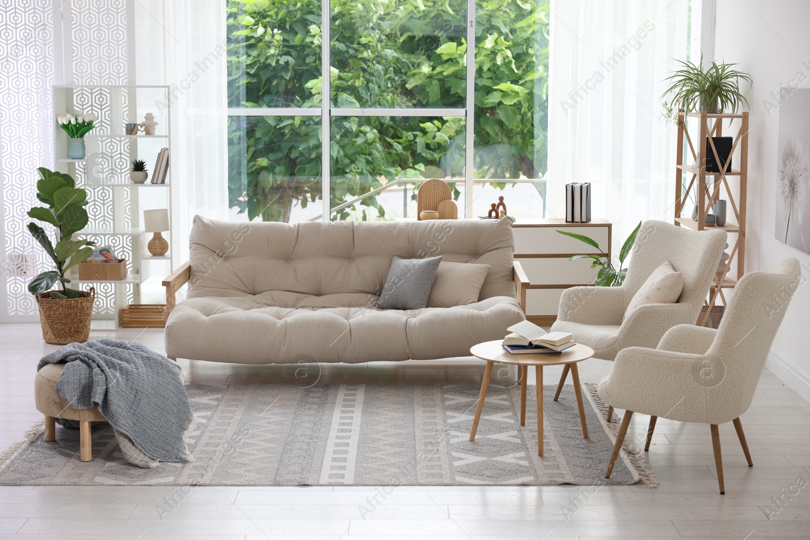 Photo of Stylish sofa and other furniture in living room. Interior design