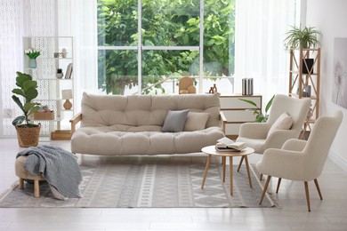 Photo of Stylish sofa and other furniture in living room. Interior design