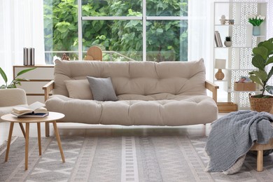 Photo of Stylish sofa and other furniture in living room. Interior design