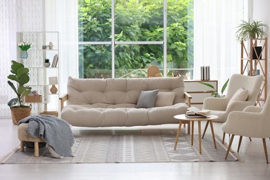 Photo of Stylish sofa and other furniture in living room. Interior design