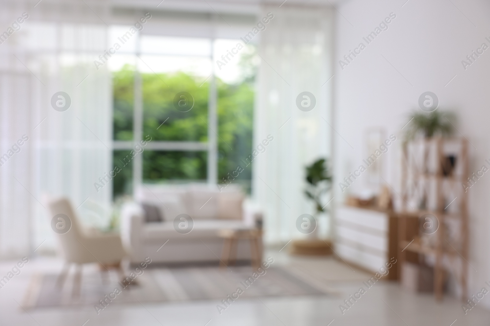 Photo of Blurred view of stylish furniture in living room. Interior design