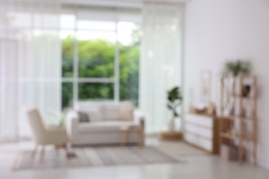 Photo of Blurred view of stylish furniture in living room. Interior design