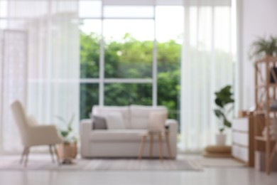 Photo of Blurred view of stylish furniture in living room. Interior design