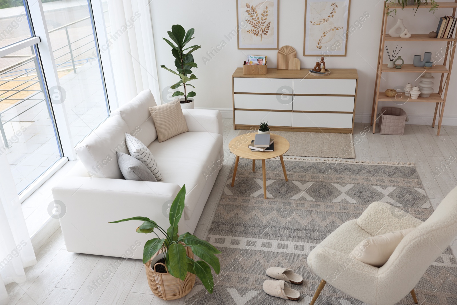 Photo of Stylish sofa and other furniture in living room. Interior design