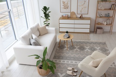 Photo of Stylish sofa and other furniture in living room. Interior design
