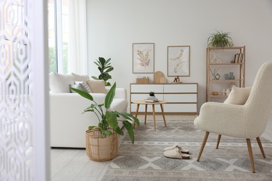 Photo of Stylish sofa and other furniture in living room. Interior design