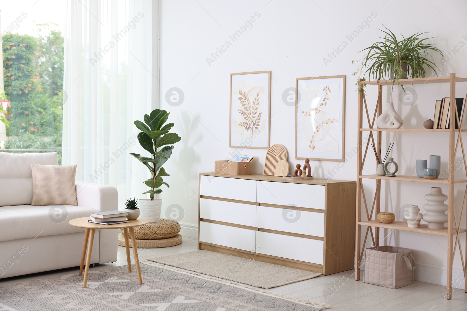 Photo of Stylish sofa and other furniture in living room. Interior design