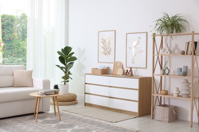Photo of Stylish sofa and other furniture in living room. Interior design