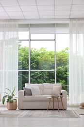 Photo of Stylish sofa and other furniture in living room. Interior design