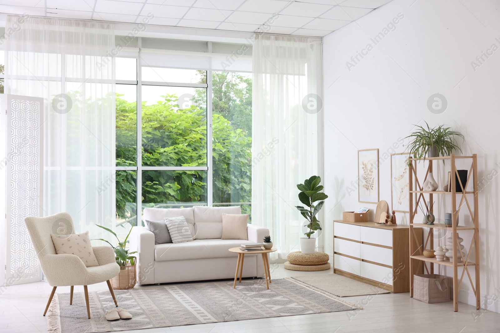 Photo of Stylish sofa and other furniture in living room. Interior design