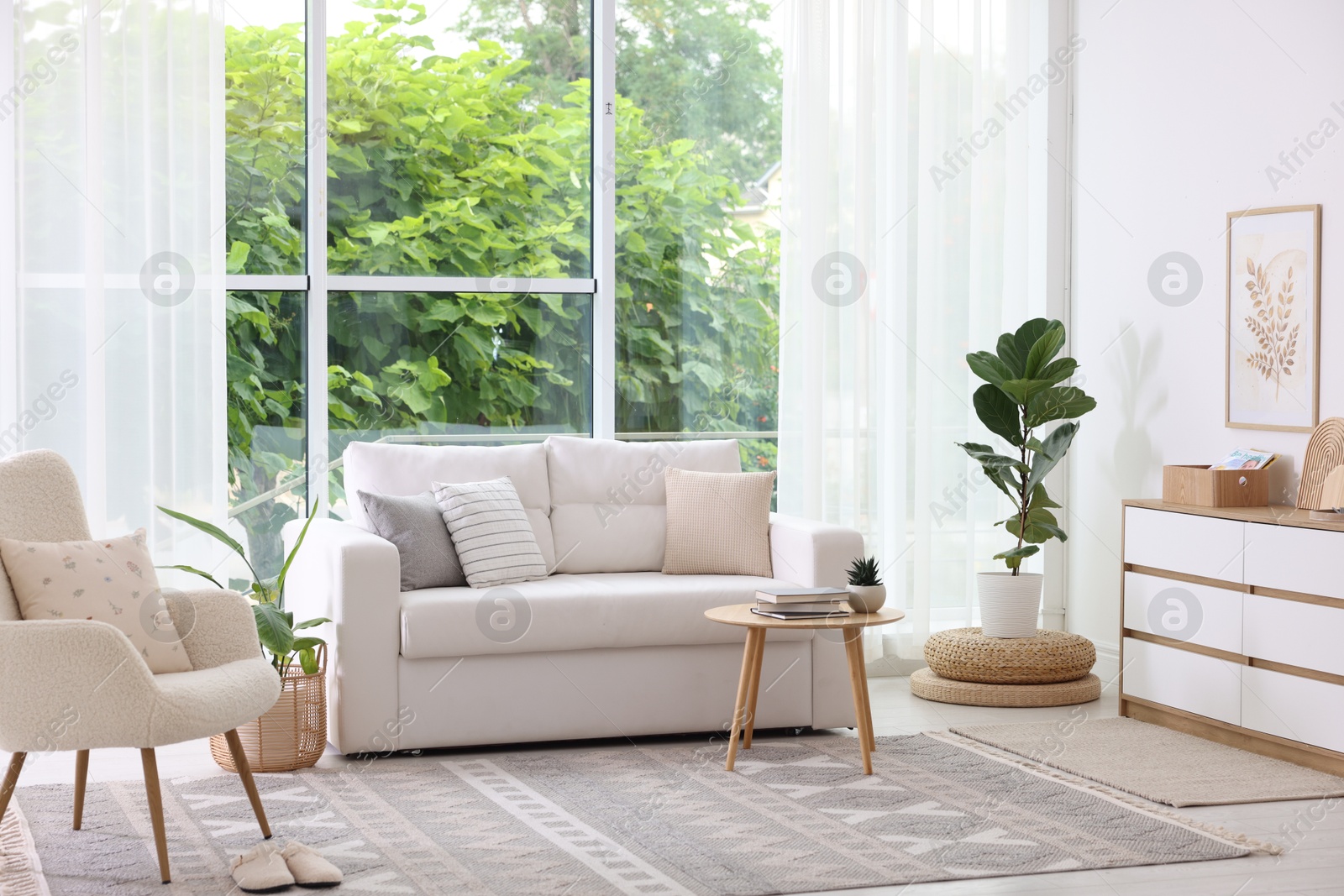 Photo of Stylish sofa and other furniture in living room. Interior design