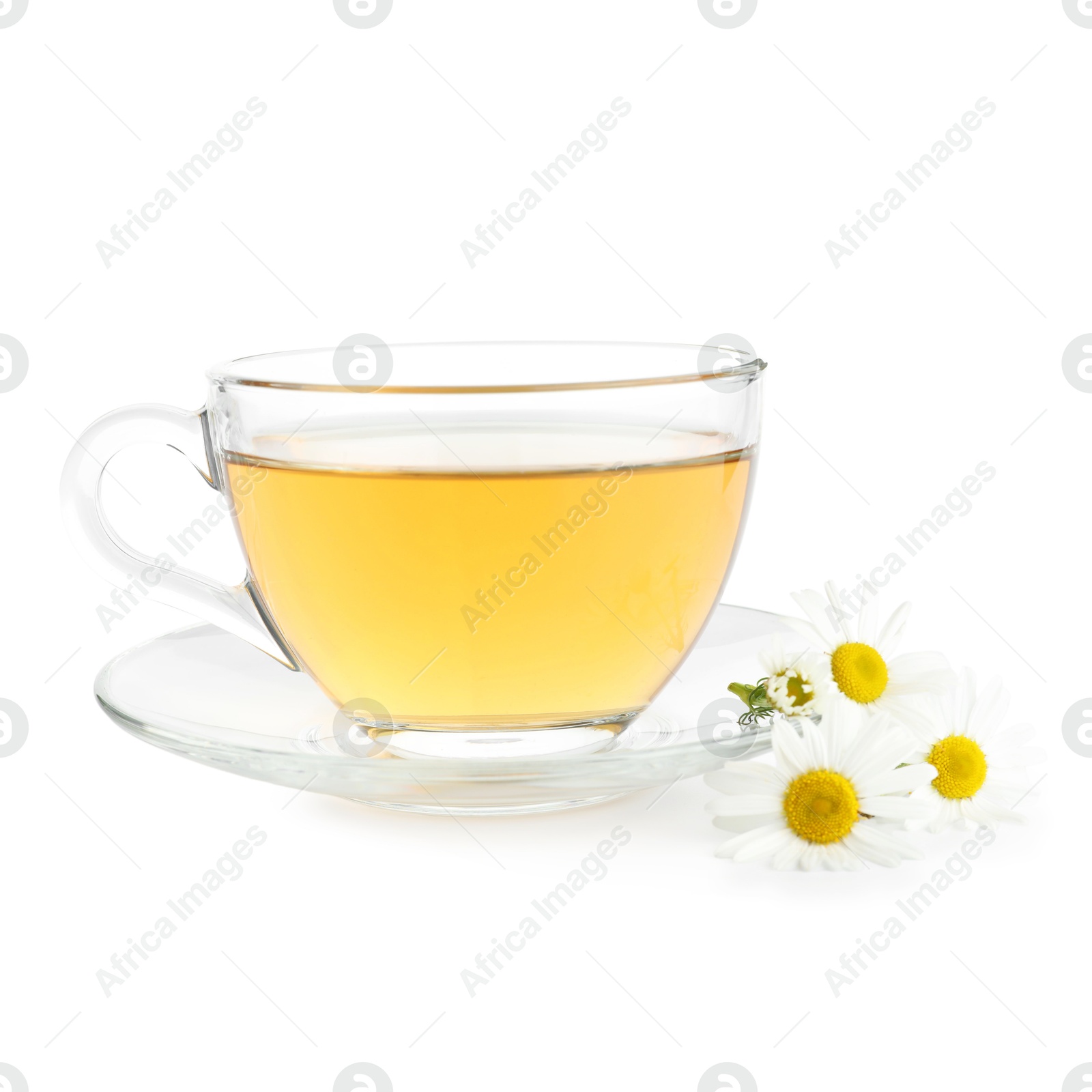 Aromatic tea in glass cup and chamomile flowers isolated on white Photo of Aromatic tea in glass cup and chamomile flowers isolated on white