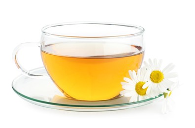 Photo of Aromatic tea in glass cup and chamomile flowers isolated on white