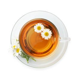 Photo of Aromatic tea in glass cup and chamomile flowers isolated on white, top view