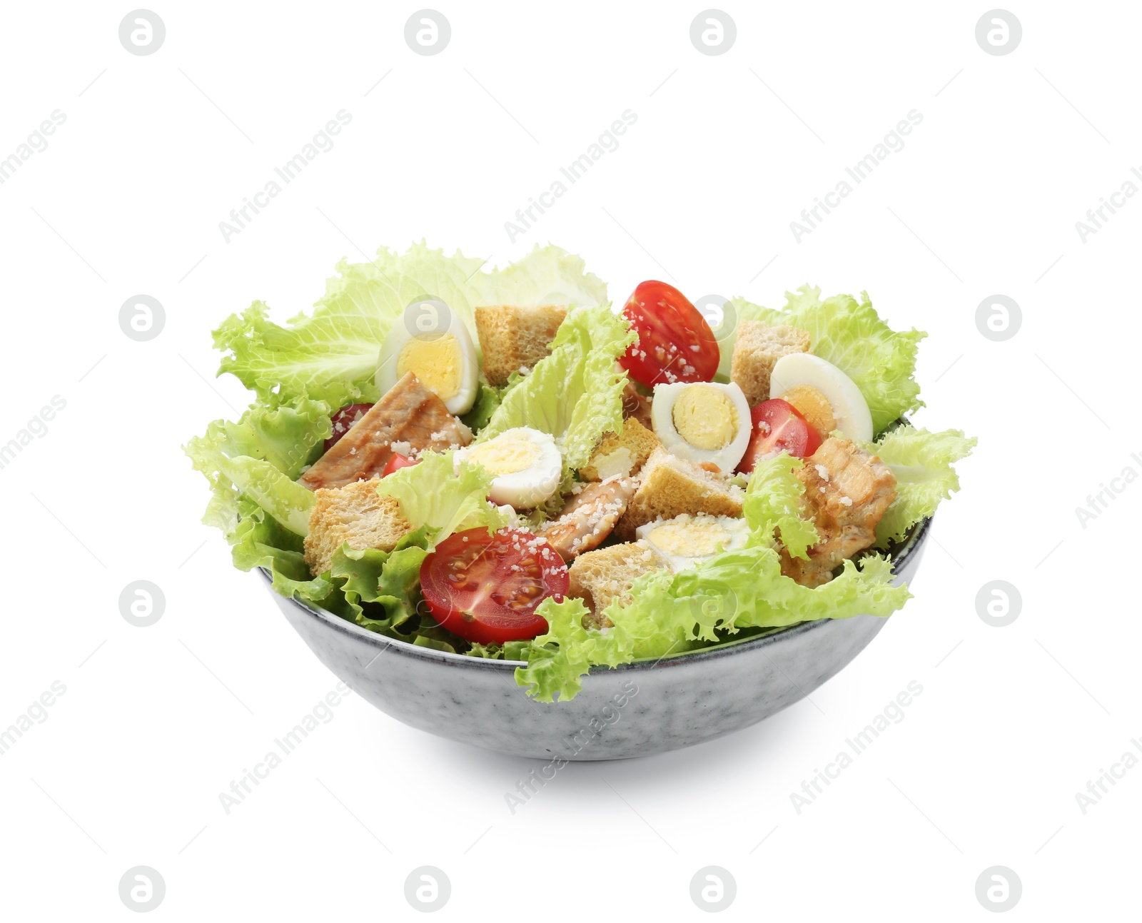 Photo of Delicious salad with croutons, chicken, quail eggs, tomato and cheese in bowl isolated on white