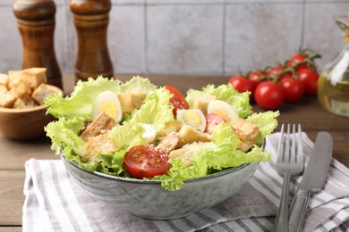 Photo of Delicious salad with croutons and ingredients on wooden table, closeup