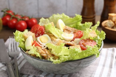 Photo of Delicious salad with croutons and ingredients on table, closeup