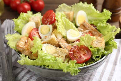 Photo of Delicious salad with croutons, chicken, quail eggs, tomato and cheese on table, closeup