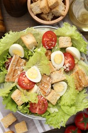 Photo of Delicious salad with croutons and ingredients on table, flat lay