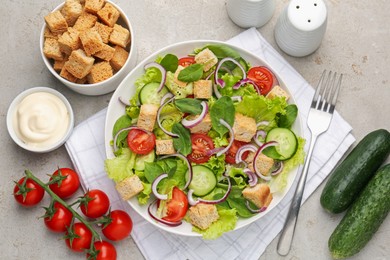 Photo of Delicious salad with croutons and vegetables served on light grey table, flat lay