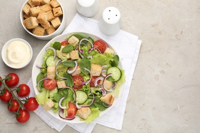 Photo of Delicious salad with croutons and vegetables served on light grey table, flat lay. Space for text