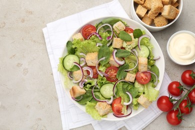 Photo of Delicious salad with croutons and vegetables served on light grey table, flat lay. Space for text