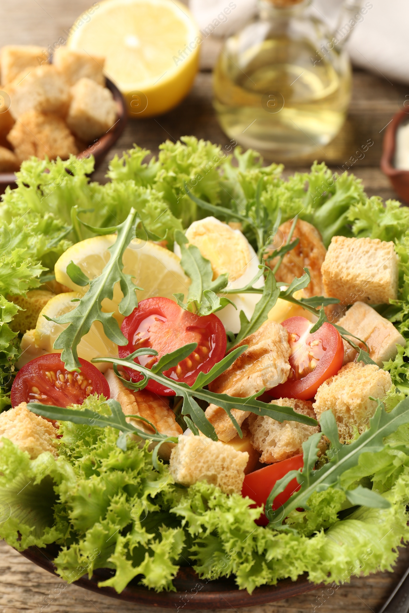 Photo of Delicious salad with croutons served on table, closeup