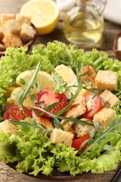 Photo of Delicious salad with croutons served on table, closeup