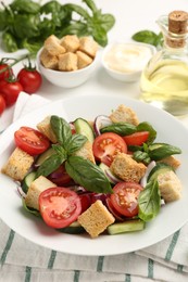 Photo of Delicious salad with croutons and ingredients on table, closeup
