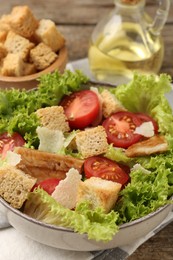 Photo of Delicious salad with croutons served on table, closeup