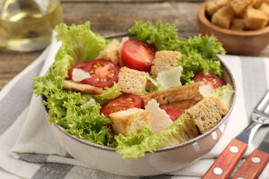 Photo of Delicious salad with croutons served on table, closeup