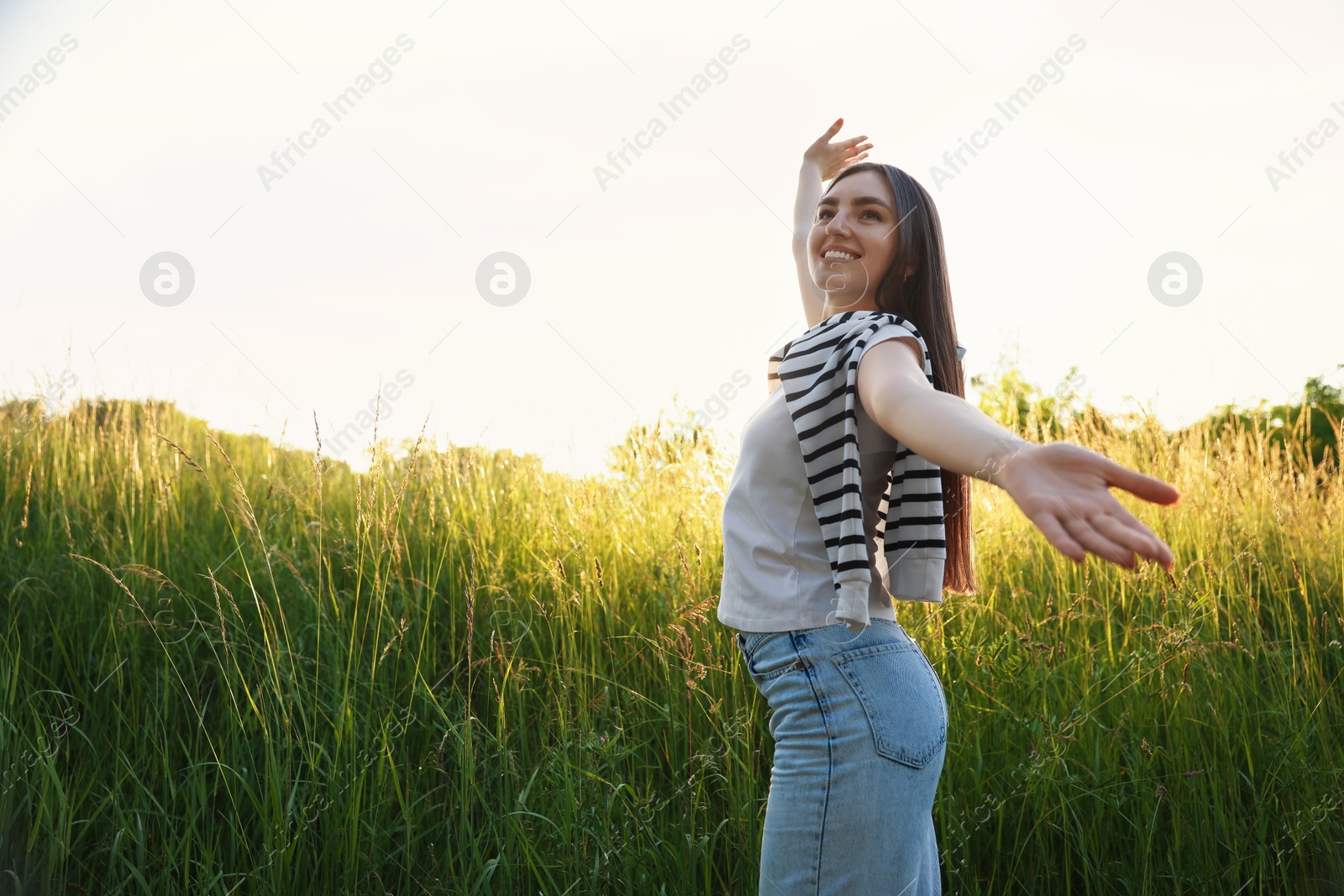Photo of Feeling freedom. Happy young woman enjoying time in nature, low angle view. Space for text