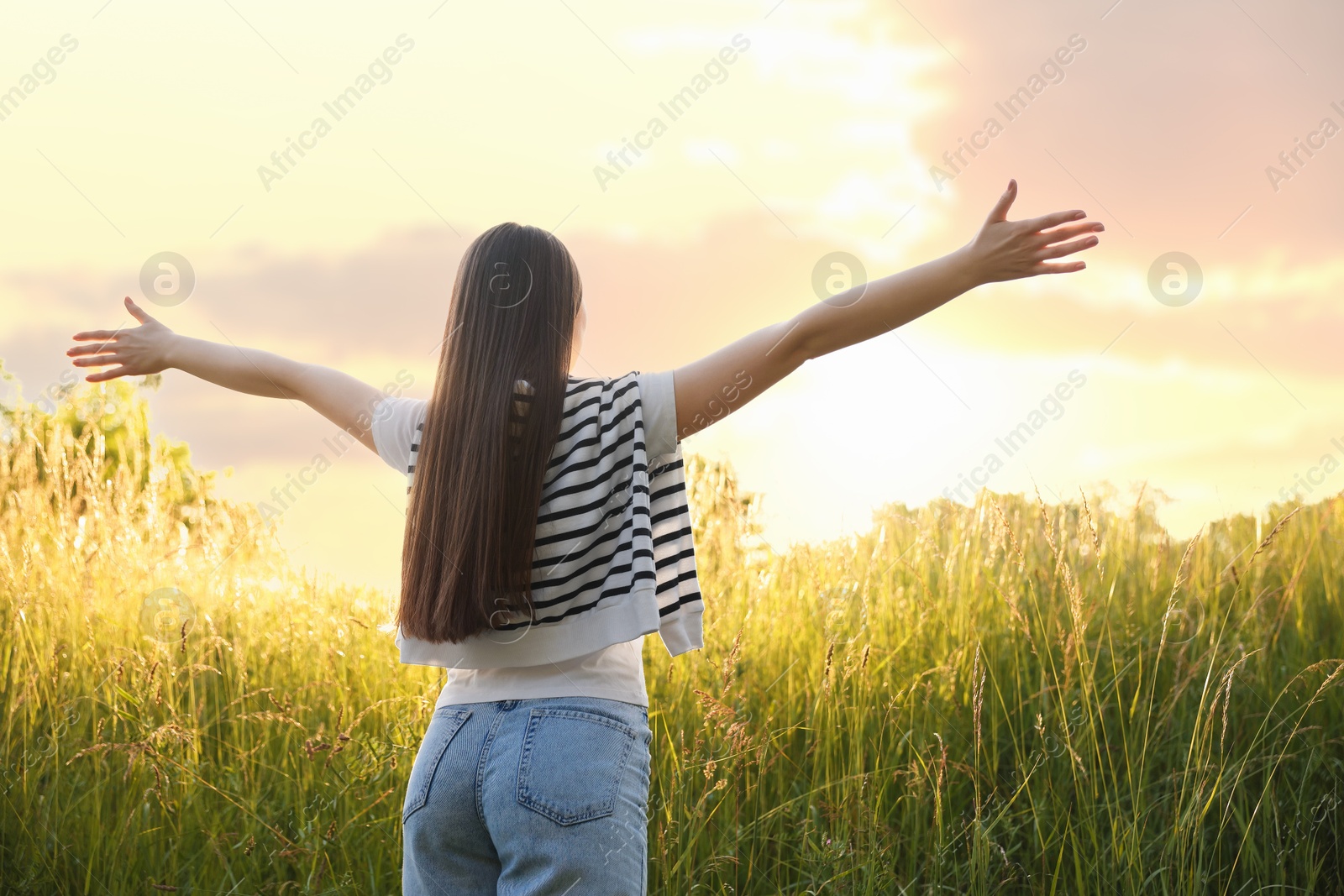 Photo of Feeling freedom. Woman enjoying time in nature, back view