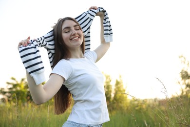 Photo of Feeling freedom. Happy young woman enjoying time in nature