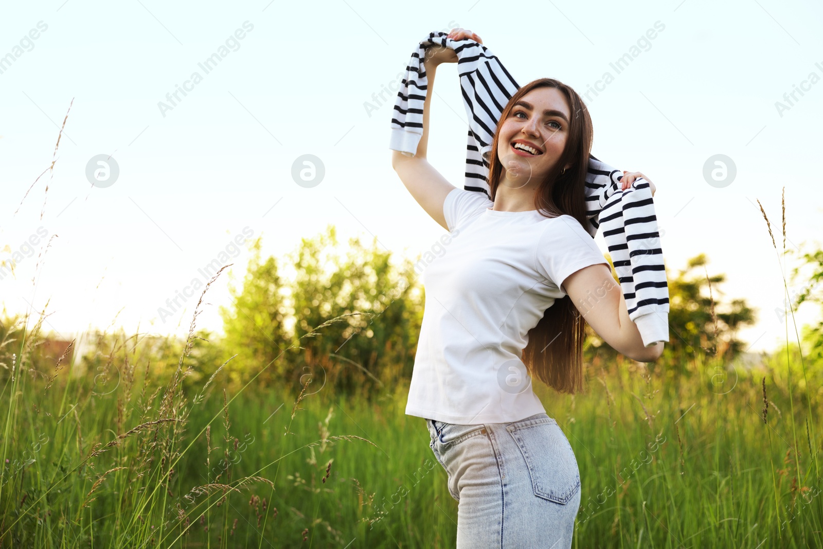 Photo of Feeling freedom. Happy young woman enjoying time in nature
