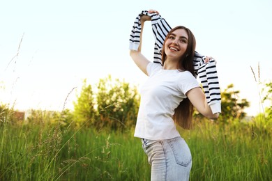 Photo of Feeling freedom. Happy young woman enjoying time in nature