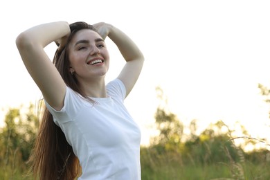 Photo of Feeling freedom. Happy young woman enjoying time in nature, low angle view. Space for text