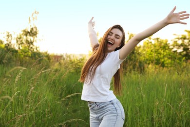 Photo of Feeling freedom. Happy young woman enjoying time in nature