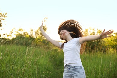 Photo of Feeling freedom. Beautiful young woman enjoying time in nature