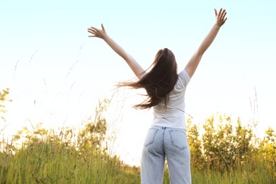 Photo of Feeling freedom. Woman enjoying time in nature, back view