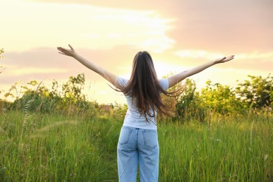 Photo of Feeling freedom. Woman enjoying time in nature, back view