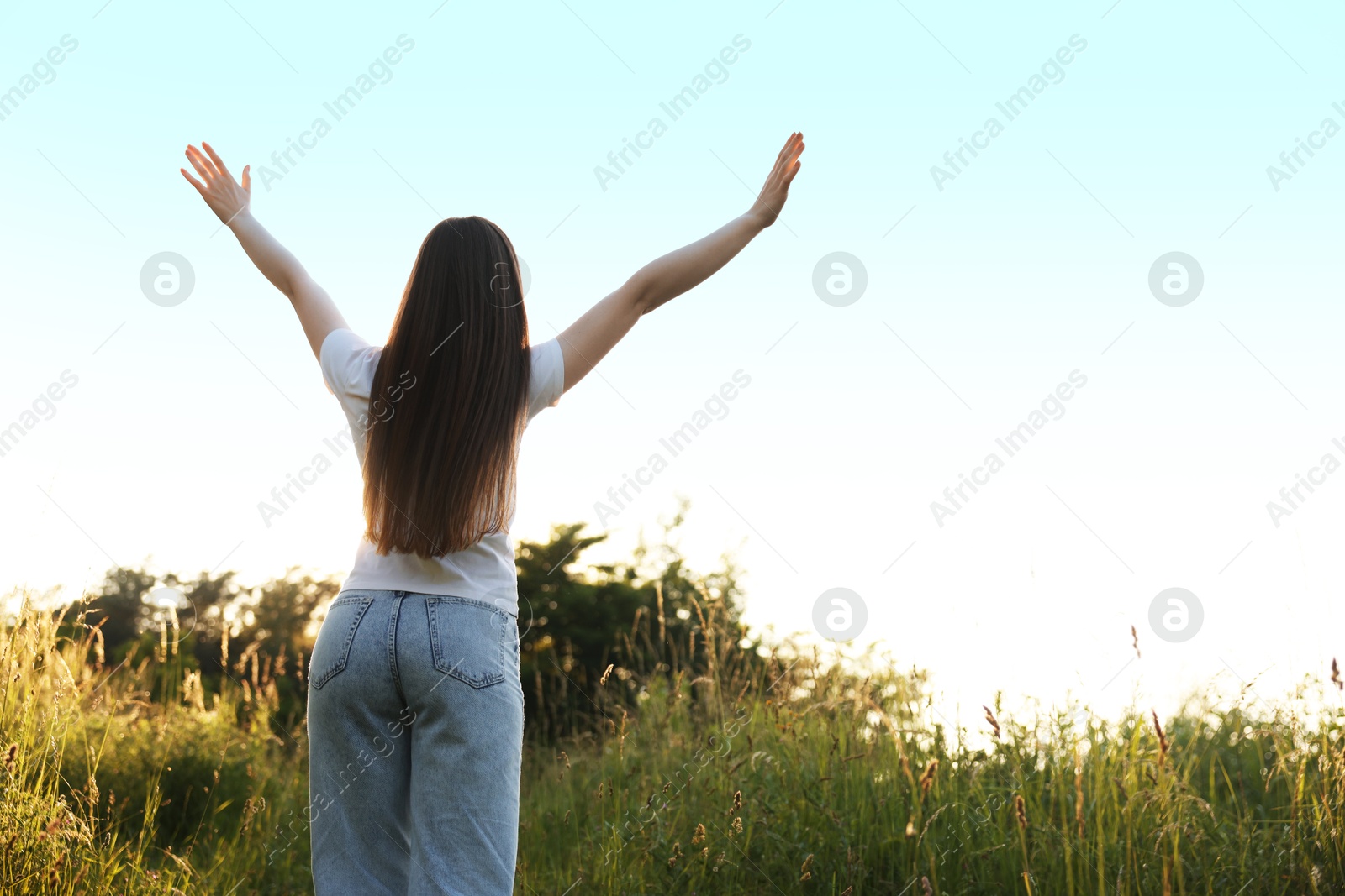 Photo of Feeling freedom. Woman enjoying time in nature, back view. Space for text