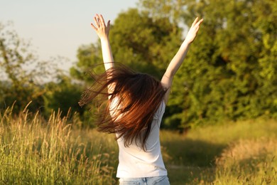 Photo of Feeling freedom. Woman running in nature, back view