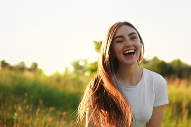 Photo of Feeling freedom. Happy young woman in nature, space for text