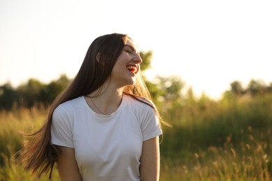 Photo of Feeling freedom. Happy young woman enjoying time in nature